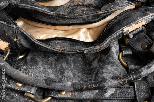 moldy leather bag on dark background close up photo