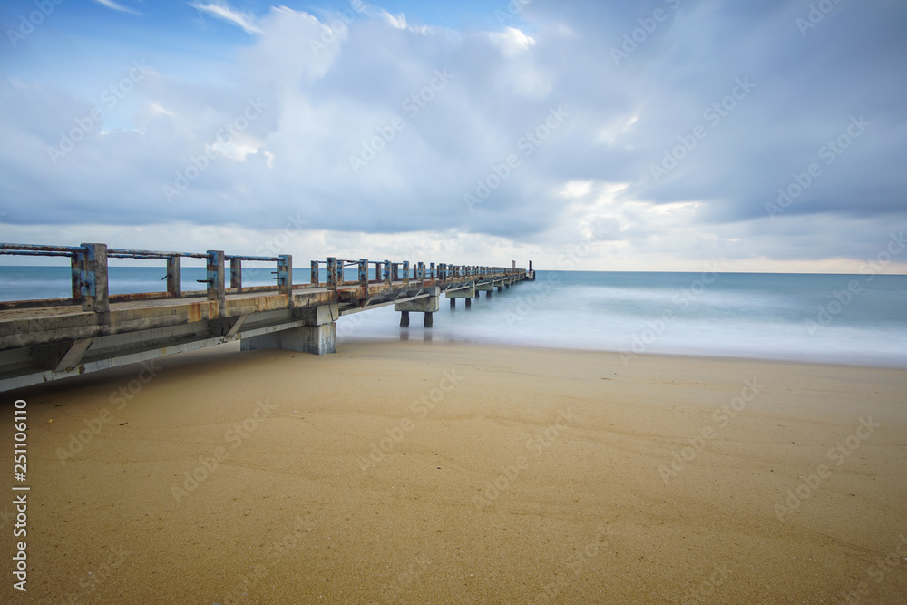 Fototapeta premium Boardwalk on beach at sunrise . Awana Kijal, Kemaman. Malaysia. 