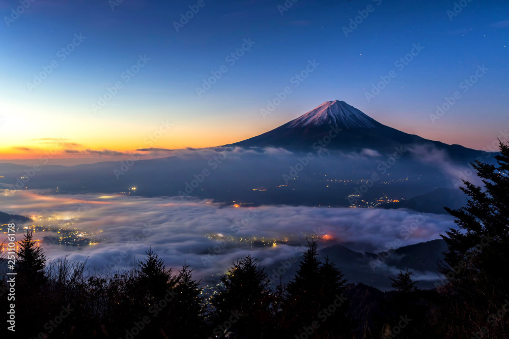 Fuji mountain and the mist over Lake Kawaguchiko at beautiful sunrise , Yamanashi, Japan, Mount Fuji or Fujisan located on Honshu Island, is the highest mountain in Japan.