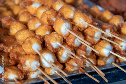 Fried balls in deep fat with sticks, Thai style food. Street fast food in Thailand, closeup
