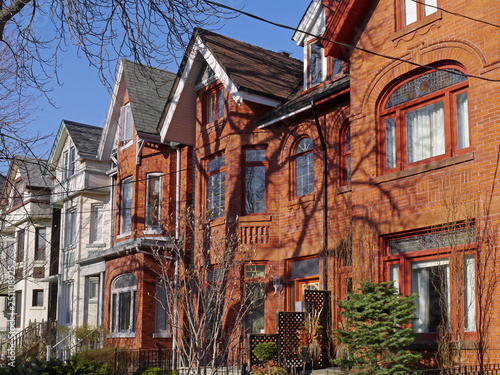 Photography street of restored Victorian brick row houses with gables