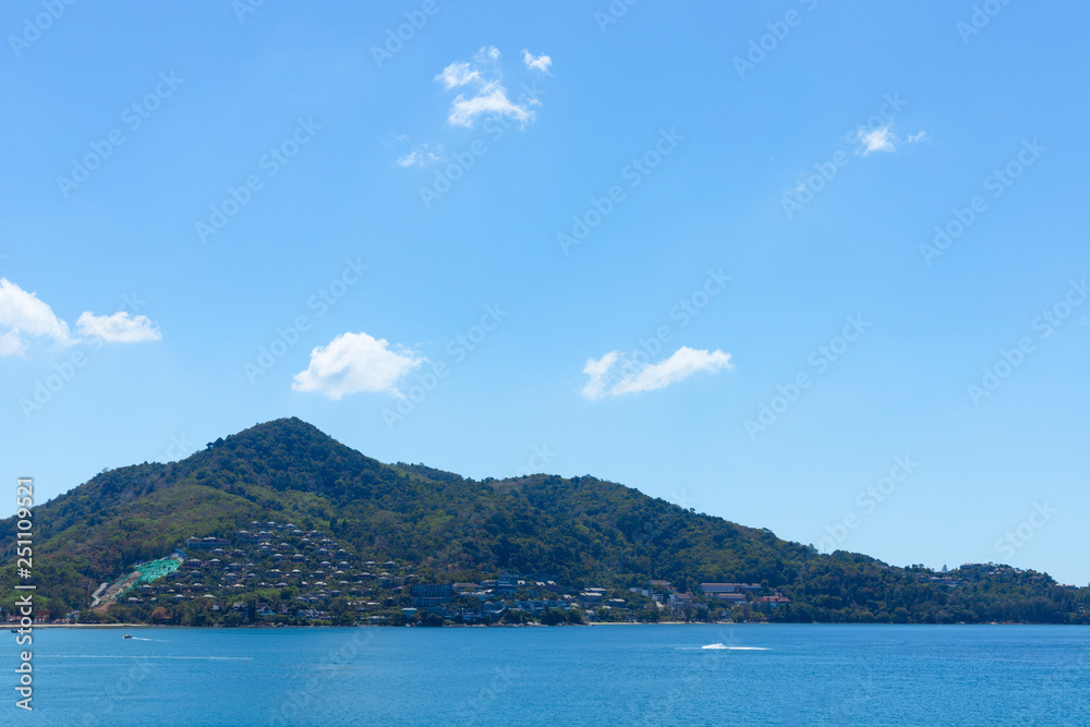 Blue sky and ocean in cleary day, have Phuket island that can see a lot of hotel near beach on mountain