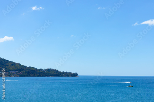 Blue sky and ocean in cleary day, have Phuket island and long tail boat drive pass through © TeeRaiden