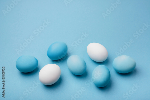 Group ombre blue Easter eggs on colorful background. close up