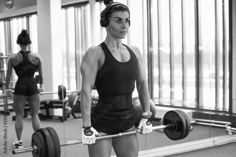 Fitness young girl in the gym doing exercises Fitness young girl in the gym doing exercises