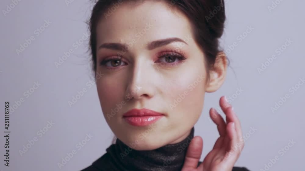 Beautiful woman touches skin of face. Caucasian adult girl cares of skin face. Beautiful brunette woman. Slow motion footage. Beauty treatment. Young woman touches her healthy face. Beautiful woman touches skin of face. Caucasian adult girl cares of skin face. Beautiful brunette woman. Slow motion footage. Beauty treatment. Young woman touches her healthy face.