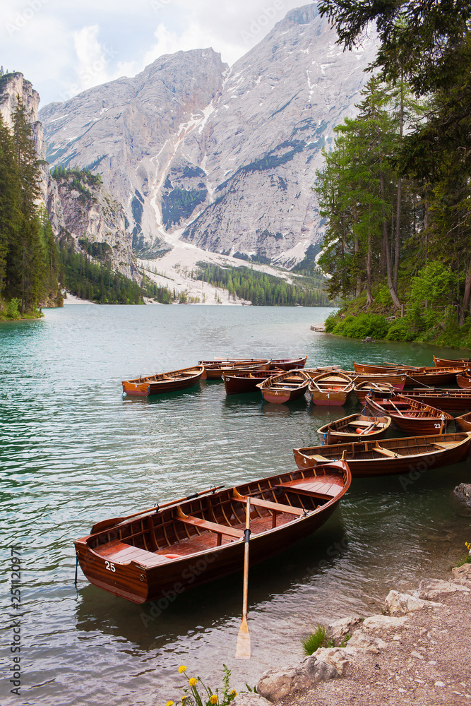 Red boats moored on a mountain lake in the Alps