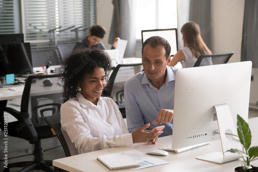 Multiracial colleagues communicate sitting in the office