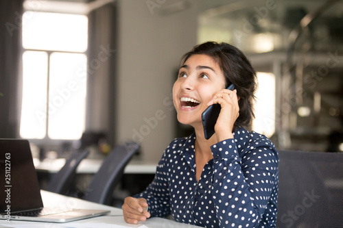 Happy smiling worker talking by mobile phone