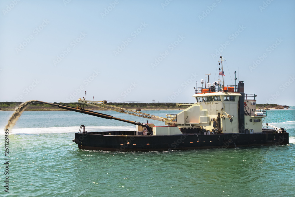 Dredge boat removing sand and silt from the bottom. Dredger ship works.Pumping sand.