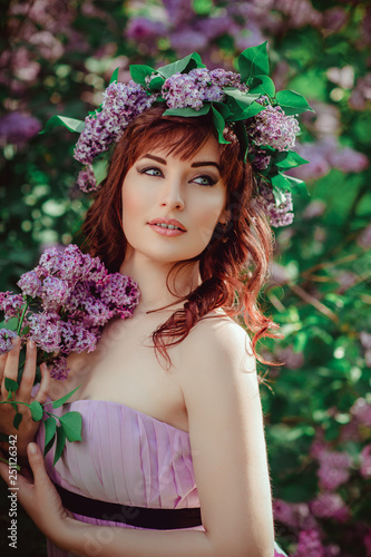 beautiful girl in purple dress with lilac flowers