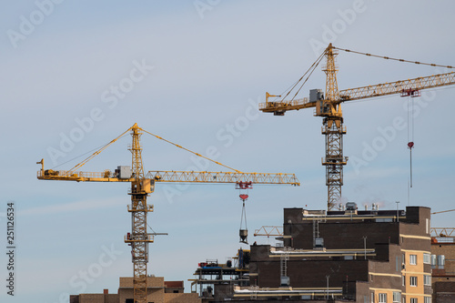 Tower construction cranes building new house