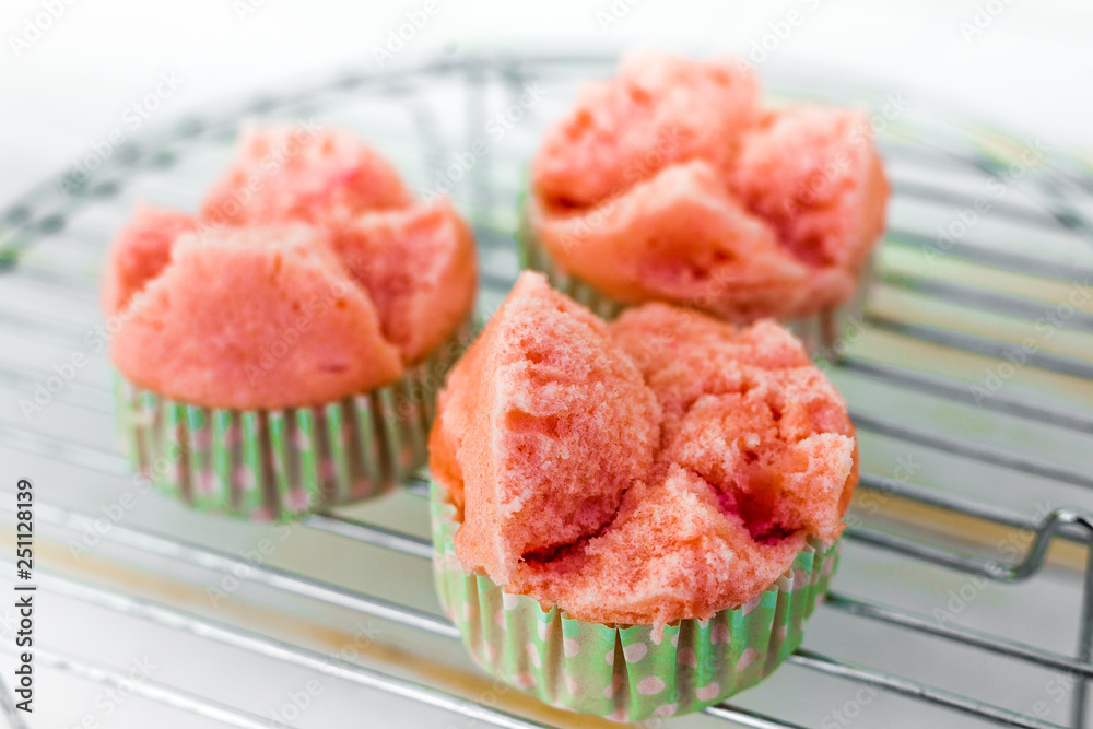 Thai steamed sponge pink cake cooling on a tray Thai steamed sponge pink cake cooling on a tray