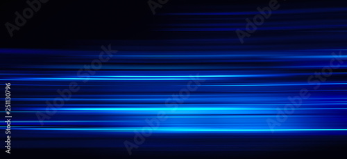 Abstract blue light trails on the dark background
