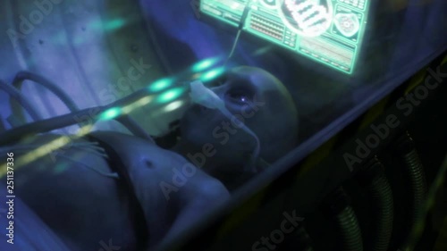 dead humanoid alien lying on the table