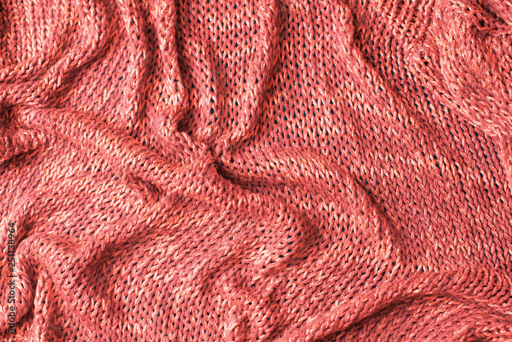 Knitted texture background coral top view flat