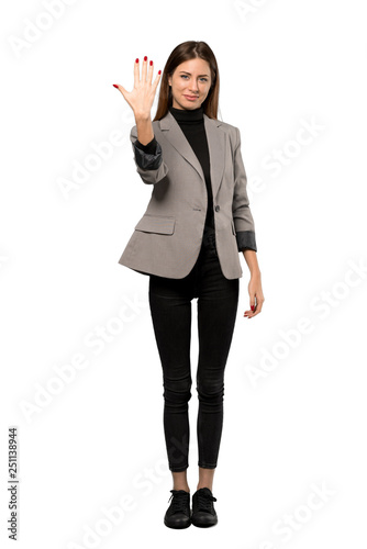 A full-length shot of a Business woman counting five with fingers over isolated white background