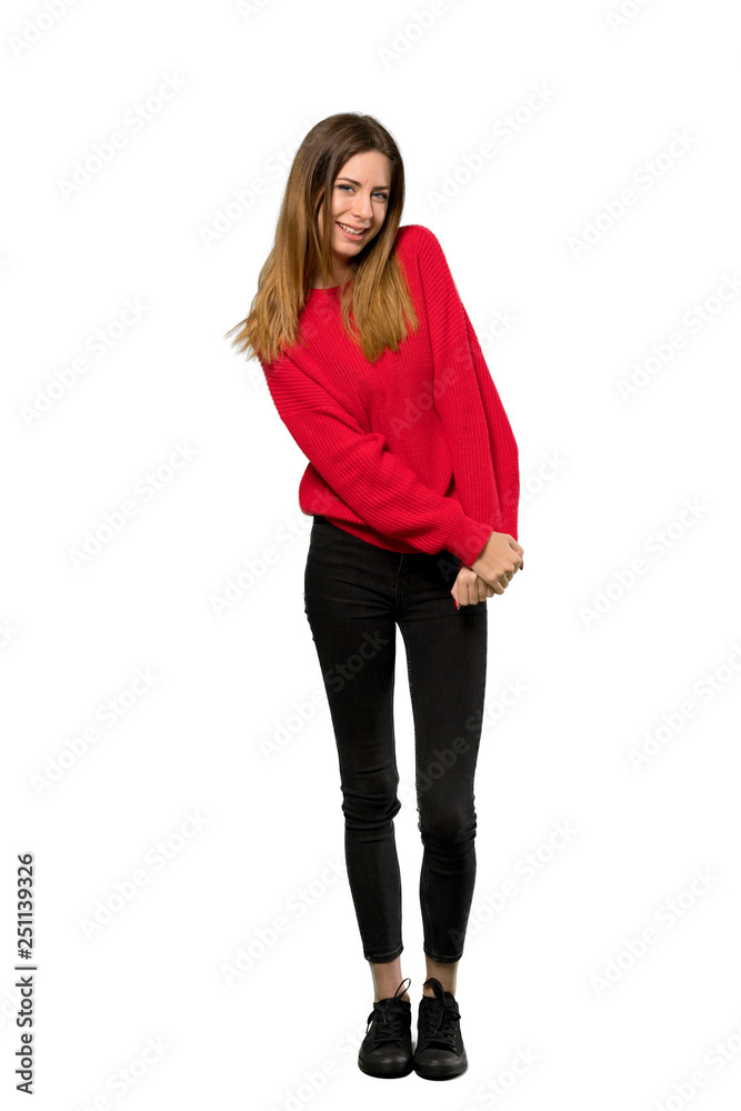 A full-length shot of a Young woman with red sweater smiling over isolated white background A full-length shot of a Young woman with red sweater smiling over isolated white background