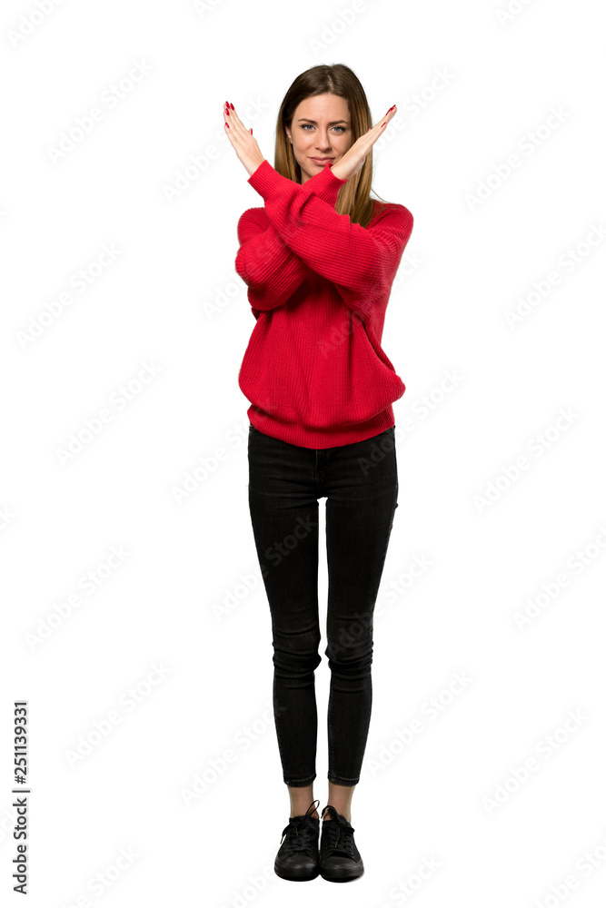 A full-length shot of a Young woman with red sweater making NO gesture over isolated white background A full-length shot of a Young woman with red sweater making NO gesture over isolated white background