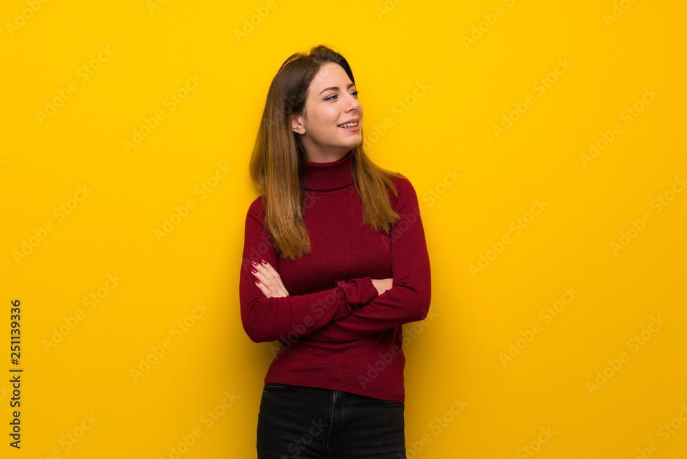 Woman with turtleneck over yellow wall Happy and smiling Woman with turtleneck over yellow wall Happy and smiling