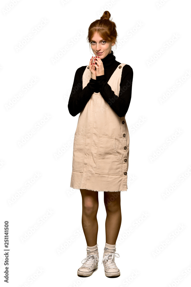 A full-length shot of a Young redhead woman scheming something over isolated white background A full-length shot of a Young redhead woman scheming something over isolated white background