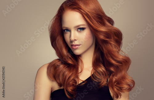 Fototapeta Beautiful model  girl with long curly red hair