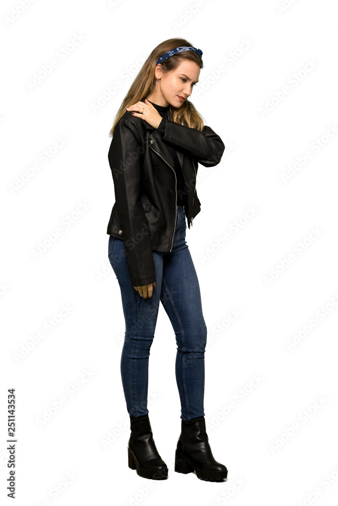 A full-length shot of a Teenager girl with leather jacket suffering from pain in shoulder for having made an effort on isolated white background A full-length shot of a Teenager girl with leather jacket suffering from pain in shoulder for having made an effort on isolated white background