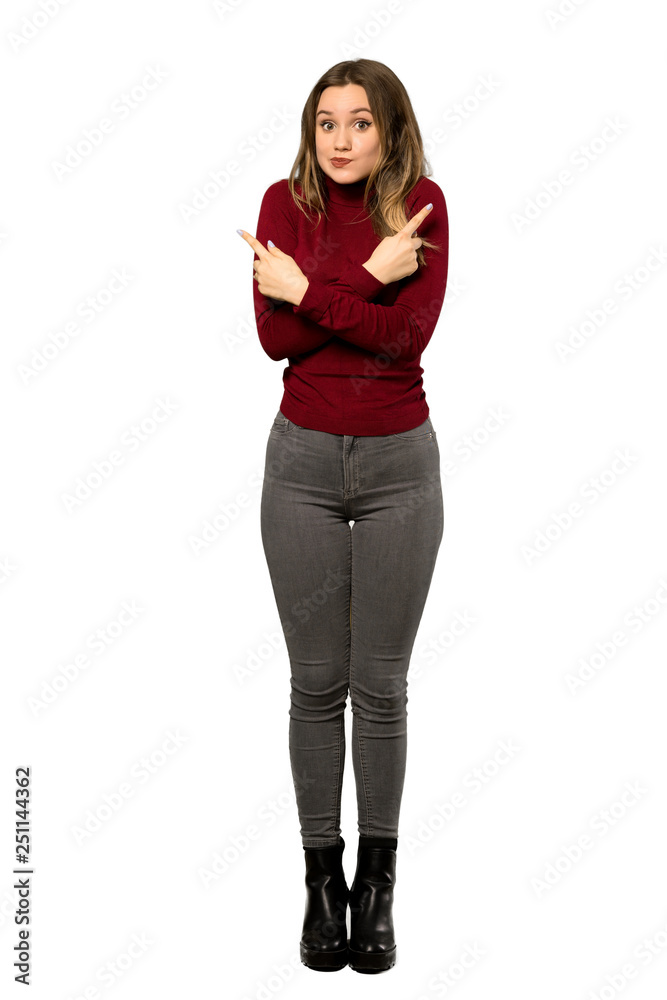 A full-length shot of a Teenager girl with turtleneck pointing to the laterals having doubts over isolated white background A full-length shot of a Teenager girl with turtleneck pointing to the laterals having doubts over isolated white background