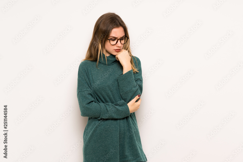Teenager girl over white wall having doubts Teenager girl over white wall having doubts