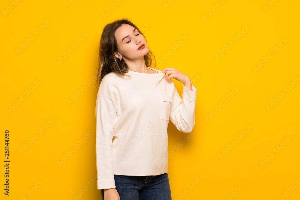 Teenager girl over yellow wall with tired and sick expression Teenager girl over yellow wall with tired and sick expression
