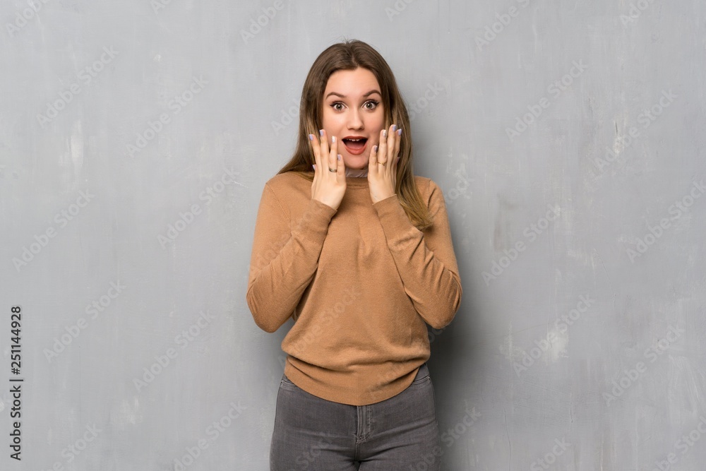 Teenager girl over textured wall with surprise facial expression Teenager girl over textured wall with surprise facial expression