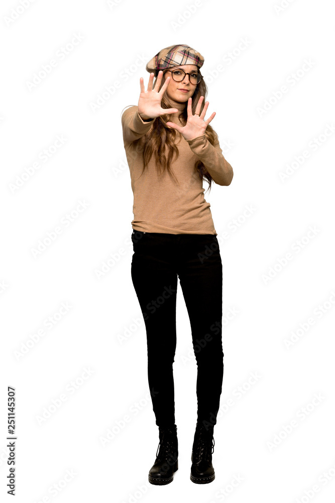 Full-length shot of Young woman with beret is a little bit nervous and scared stretching hands to the front on isolated white background Full-length shot of Young woman with beret is a little bit nervous and scared stretching hands to the front on isolated white background