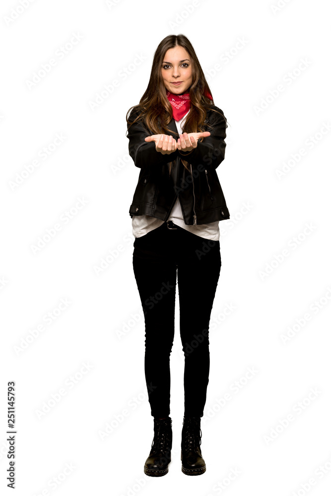 Full-length shot of Young woman with leather jacket holding copyspace imaginary on the palm to insert an ad on isolated white background Full-length shot of Young woman with leather jacket holding copyspace imaginary on the palm to insert an ad on isolated white background