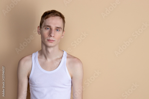 Young serious man posing and looking at camera