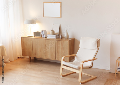 Obraz na płótnie Modern minimalistic interior with chest of drawers an braided armchair. Scandinavian style. w salonie