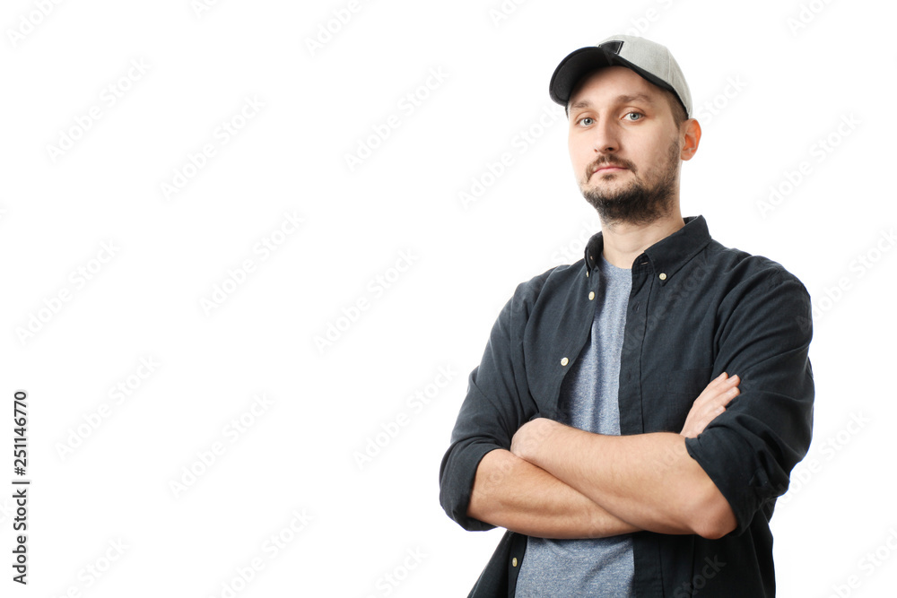 Fashionable white man with beard and cap crossed his arms. Fashionable white man with beard and cap crossed his arms.