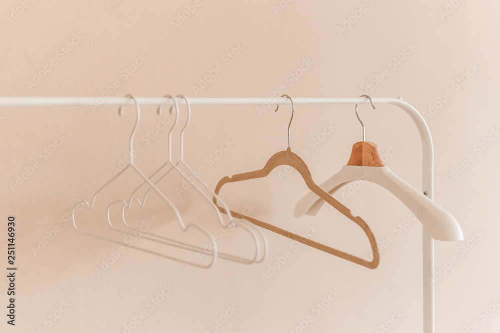 wooden coat hangers on clothes rail.