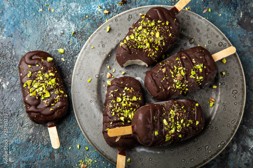 homemade vanilla ice cream with chocolate glaze and pistachios