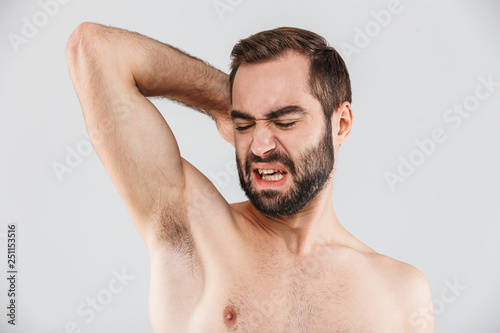 Close up portrait of a disgusted bearded man standing