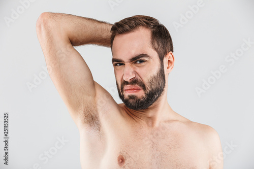 Close up portrait of a disgusted bearded man standing