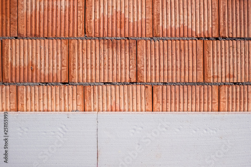 red brick wall during the works connected with the insulation of polystyrene