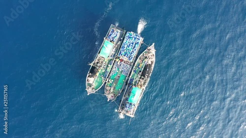 Industrial overfishing - aerial view of a fleet of large fishing trawlers operating together in a shallow ocean (Black Rock, Mergui Archipelago)