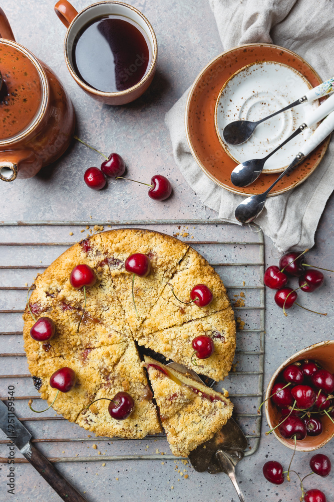 Homemade cherry crumble pie with fresh berries on rustic background, top view Homemade cherry crumble pie with fresh berries on rustic background, top view