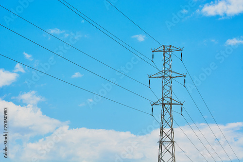 Electric transmission line with steel wires stretched against sky.