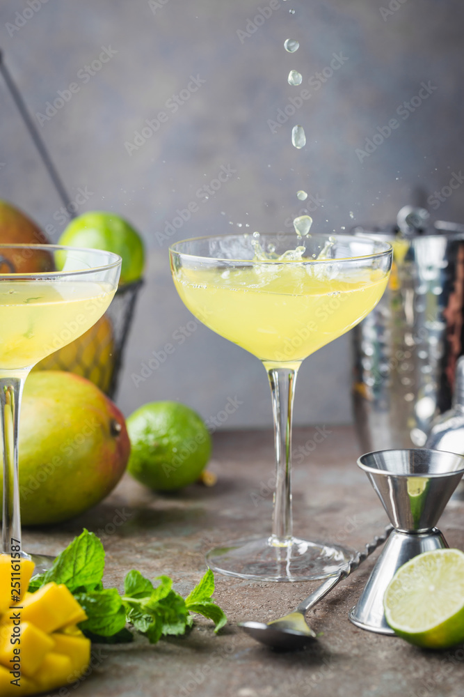 Margarita Mango alcoholic cocktail in a glass on stone background.