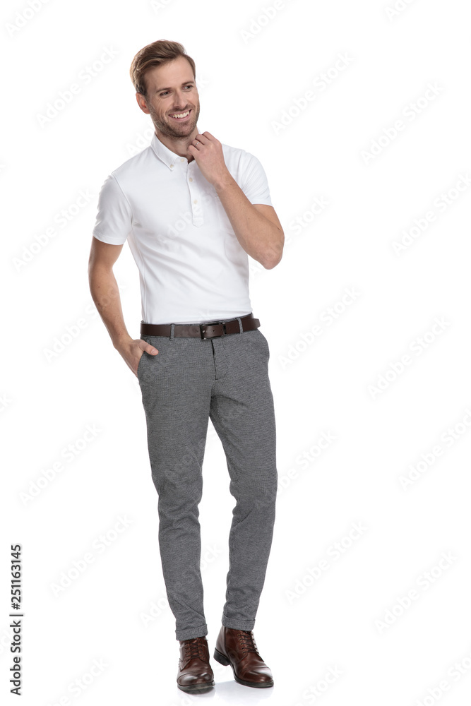 laughing young casual man adjusting collar and looking away laughing young casual man adjusting collar and looking away