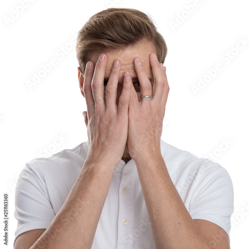 man covering his face with his palms
