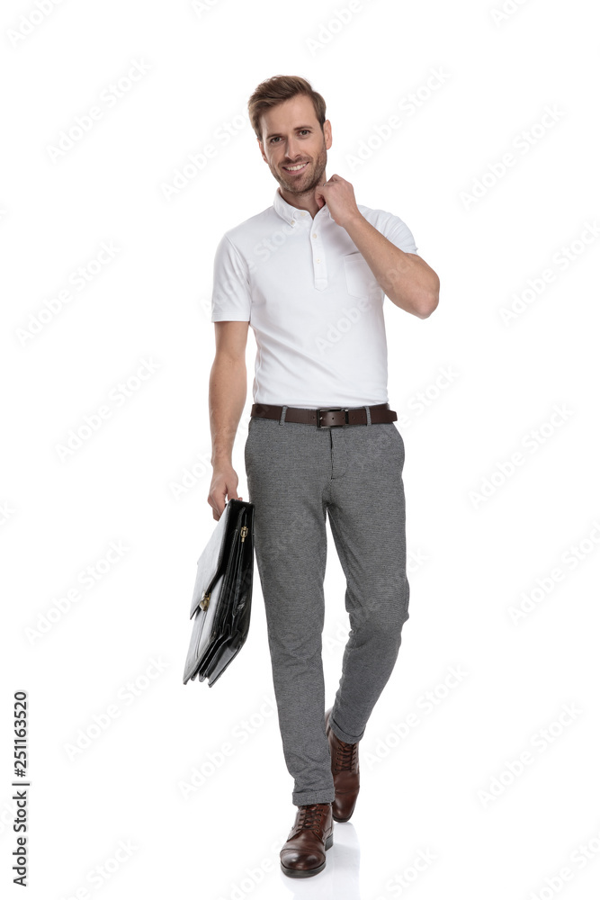 Fototapeta premium asual man is walking with briefcase and adjusts his collar