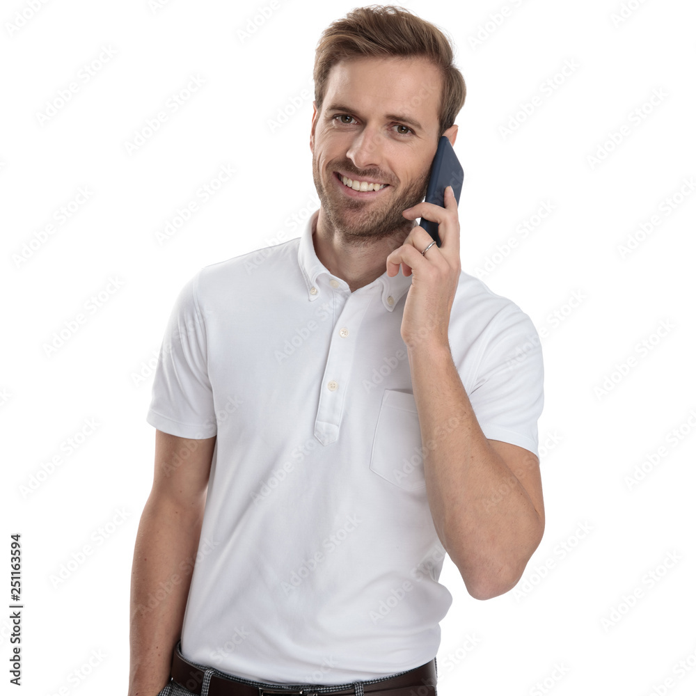 happy young casual man is talking on his mobile phone happy young casual man is talking on his mobile phone