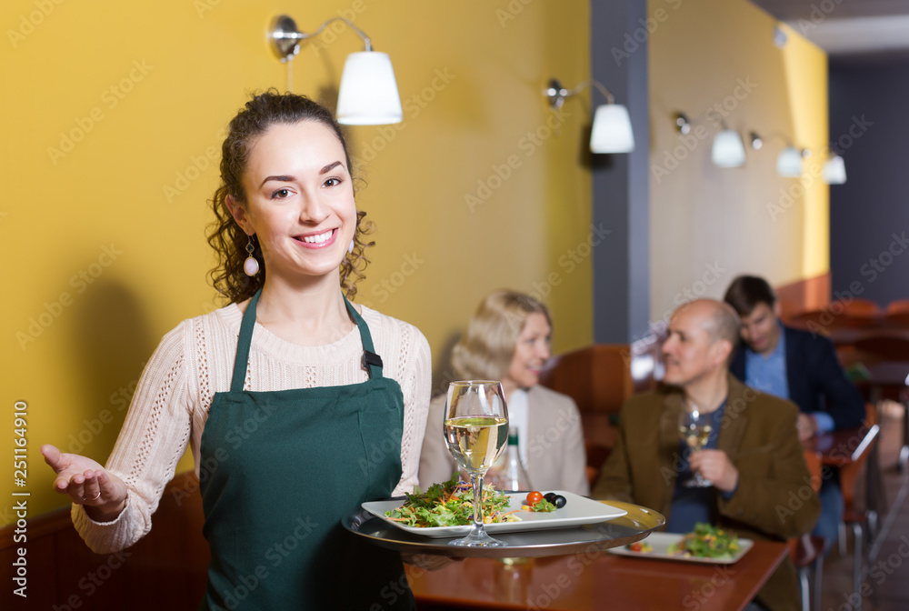 Adult young waitress greeting customers